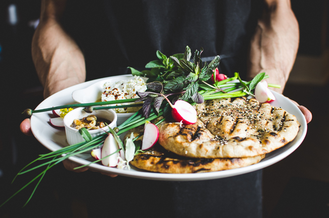 The fresh herb platter with feta, walnuts, and house-made pita. Photo by Aubrey Dunnuck