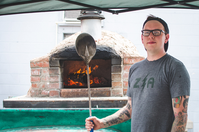 Adam Sweet with his portable oven. Photo by Aubrey Dunnuck