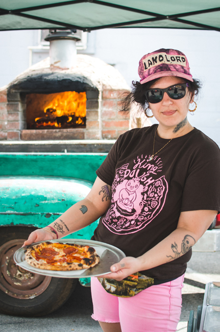 Angela Lamonica shows off a pizza pie. Photo by Aubrey Dunnuck