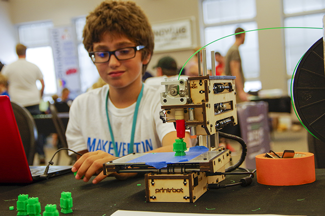 Building small green robots with his 3-D printer, 10-year -old Toby Thomassen built his printer from a kit for a fourth-grade project.