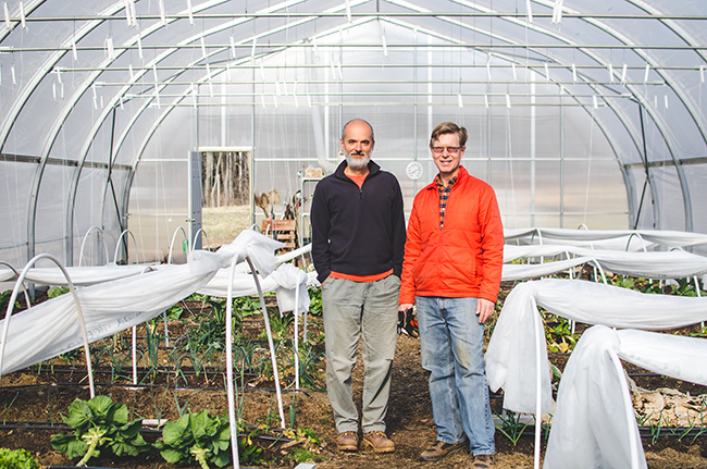 Juan Carlos Arango (left) and Robert Frew in their hoop house. Photo by Aubrey Dunnuck