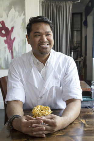 Björn DelaCruz with one of his famous Golden Cristal Ube Donuts. Photo by Maureen Drennan
