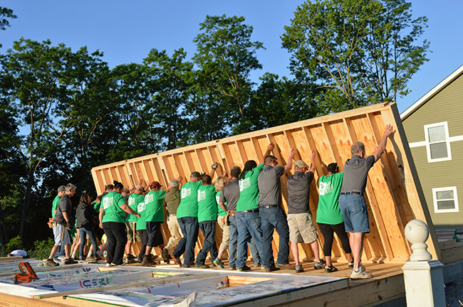 Raising the first wall at the Habitat Builders Blitz. Photo by Jaime Sweany
