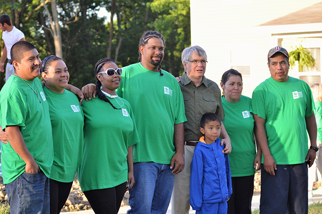 New homeowners with Bloomington Mayor John Hamilton. Photo by Jaime Sweany