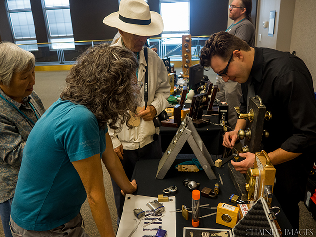 Zach Campbell from the Fraternal Order of Lockpicking Sports teaches lock picking in the Bloominglabs booth at Makevention 2015. Photo by Greg Chaney