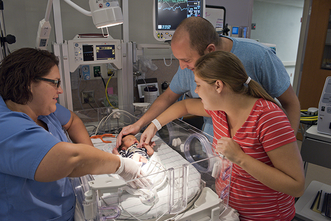 (above, l-r) Mindy Long, NP; baby Lazarus; and parents John and Claire Roth. Photo by Kendall Reeves