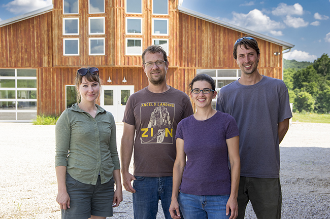 (l-r) Mary Hallinan, Spencer Goehl, Natalie Marinova, and Phil Oser in front of the Eco Logic building. Photo by Darryl Smith 