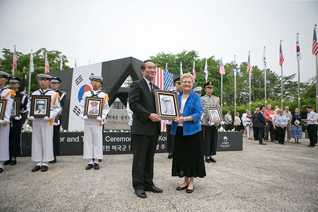 Minister Park Sungchoon presents Brenda with a portrait of her brother, Daniel Dulin, at a ceremony held by the Ministry of Patriots and Veterans Affairs in the Republic of Korea. Courtesy photos