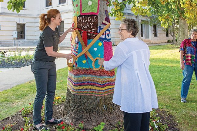 Diane Neal (left) and Toby Strout cut the "ribbon" on the Middle Way House Tree. Photo by James Kellar