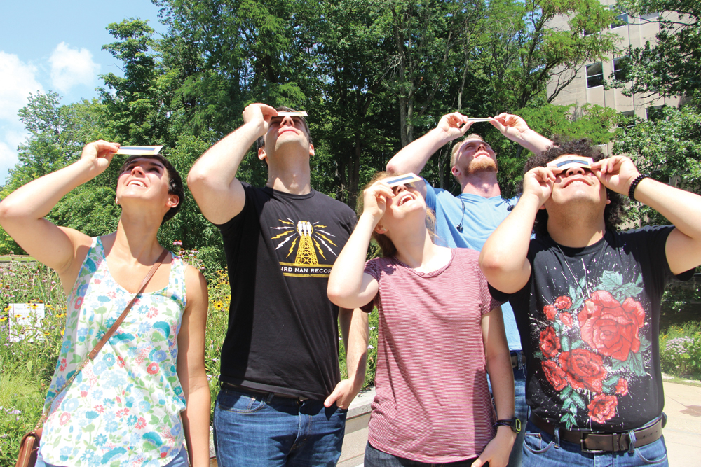 Indiana University students practice safe solar viewing with IU Solar Eclipse Cards in preparation for the August eclipse. (l-r) Kate Hummels, Chris Puccis, Madeline Danforth, Nicholas Neidig, and Mannuel Arriaga. Photo by Alexandria Eady, IU Office of Science Outreach media intern