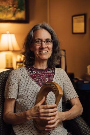 Stearns-Bruner with a hand harp, one of many instruments used during music therapy. Photo by Stephen Sproull