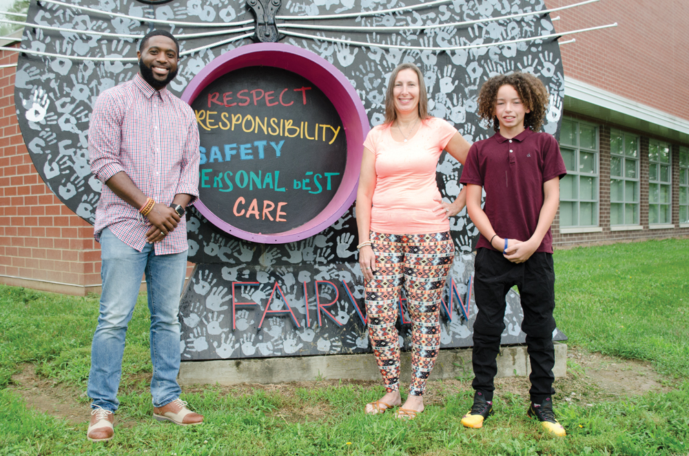 Krimson Leadership Academy founder Brian Richardson with 12-year-old Aveion Mumma (right) and his grandmother and guardian, Tammy Groomer. Photo by Mike Waddell