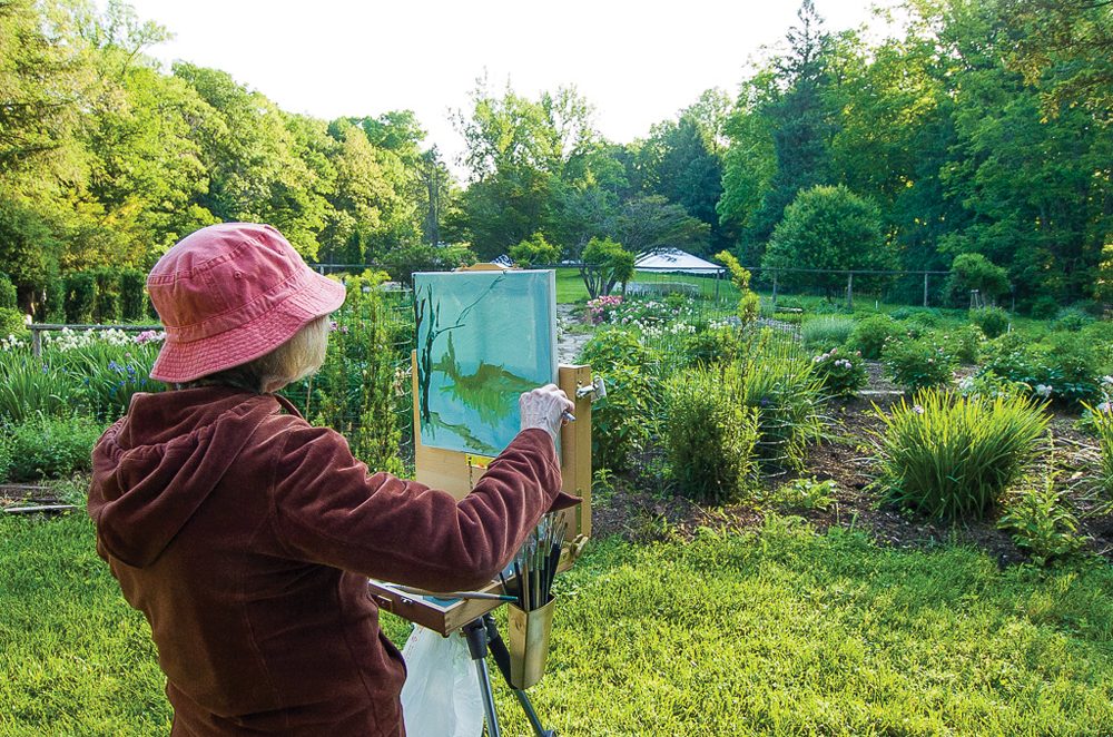 An artist paints a landscape during the Great Outdoor Art Contest at T.C. Steele State Historic Site. Photo by Rodney Margison