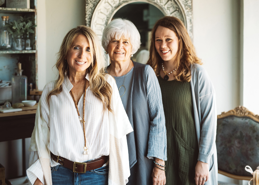 Generations of style: Shana Diekhoff in a Handloom blouse and wrap, Flying Monkey jeans, and a vintage leather belt; Mary Ellen Kerber in a Cobblestone vest and a Nusantara tunic; Amanda Calvert in a Cobblestone duster and a Nusantara tunic.