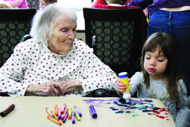 Winnie watches as Isabella Pandolfo creates an array of dots with her paint marker. Photos by Nicole McPheeters