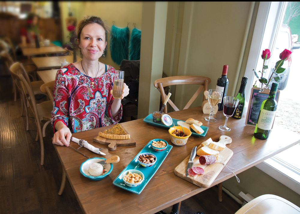 Stéphanie Laparre at a table set for aperitif at her café, La Vie en Rose. Photo by Naama Levy