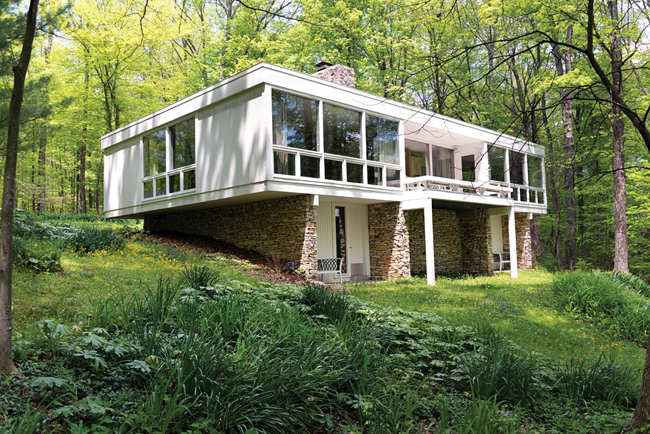 Appearing to float amid a forested hillside northwest of Bloomington, Larry Phelps’ house embodies numerous elements of the modernist design school known as International Style. Photo by Kendall Reeves
