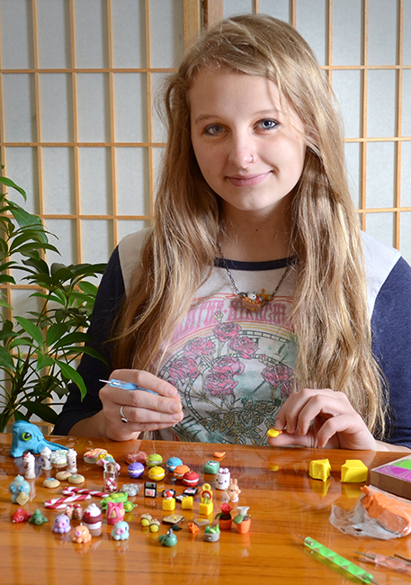 Autumn Siney with a selection of her miniatures. Photo by Patrick Siney.