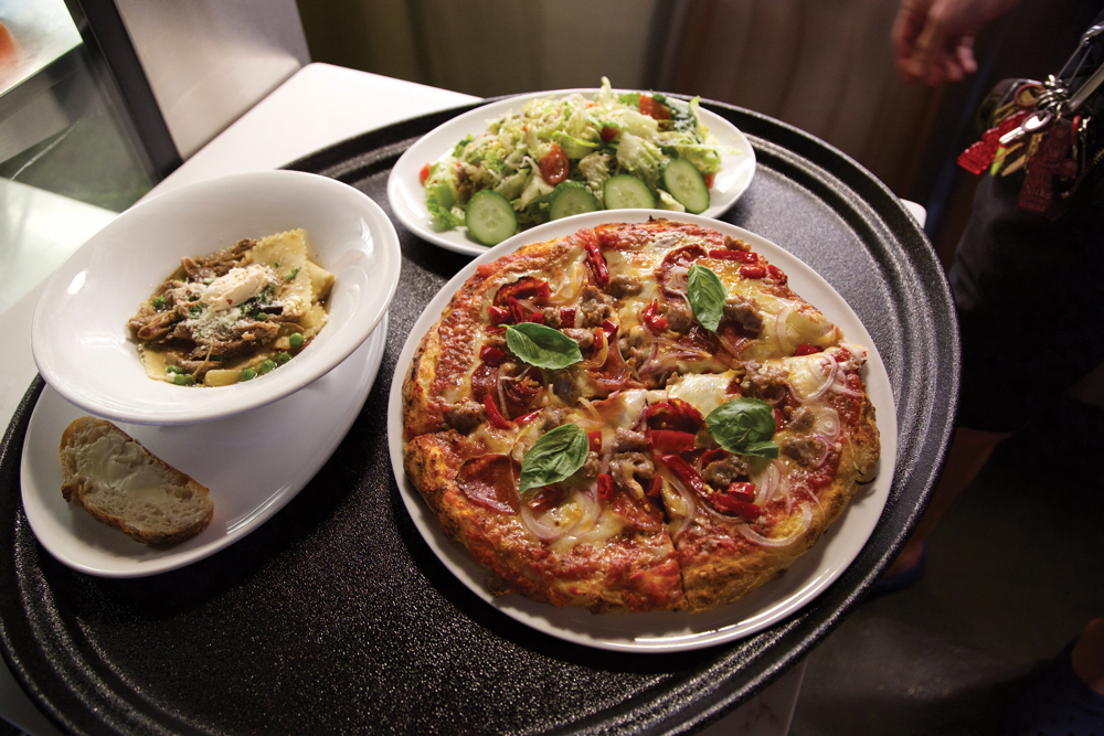 A platter with Fazzoletti in Pork Sugo, chopped salad, and Margherita pizza at Osteria Rago. Photo by Jim Krause