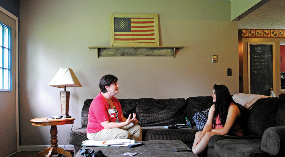 Isis Spaulding, RN, (left) visits with expectant mother Brianna Springer. Photo by Nicole McPheeters