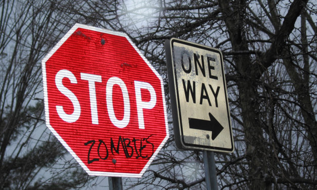 Vandalized Stop Signs With Many Messages
