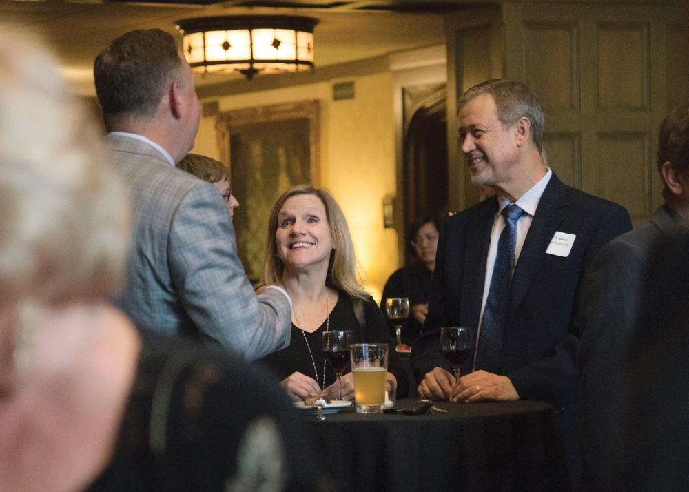 Old National Bank’s Scott Shishman (back to camera) chats with attorney Angela Parker of CarminParker, P.C., and husband, musician Bret Raper.