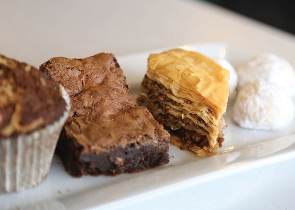 Dessert sampler: powerhouse carrot cake muffin, double chocolate brownie, baklava, and wedding cookies, all made in-house.