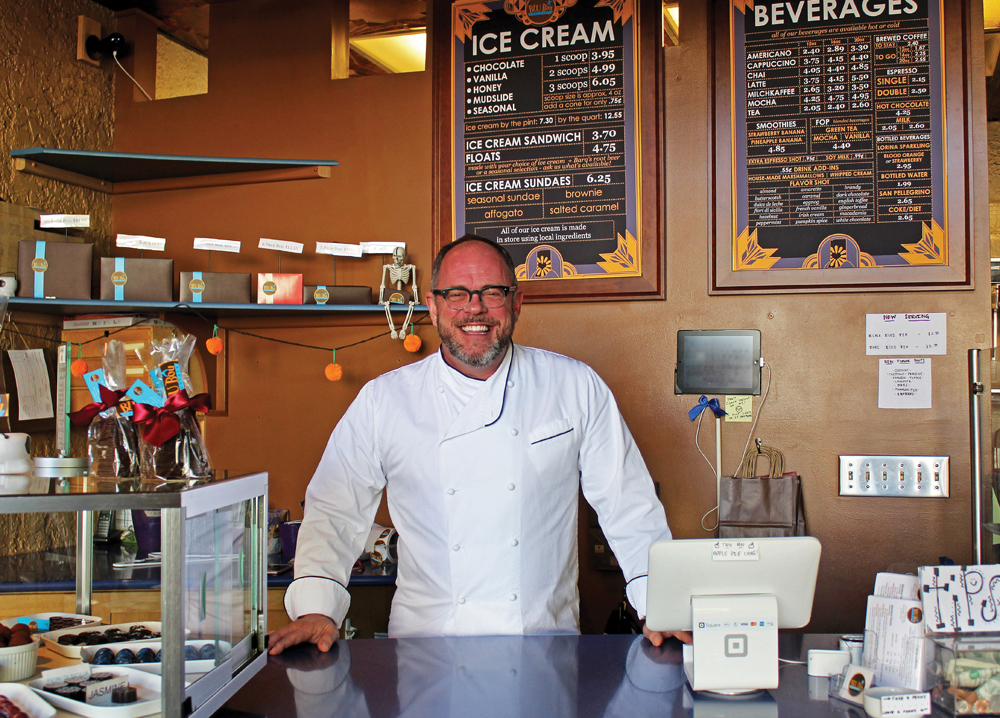David Fletcher stands behind the counter of his small Bloomington business, BLU Boy Cafe and Cakery, which serves French-themed pastries and artisan scratch-made chocolates. Photos by Nicole McPheeters