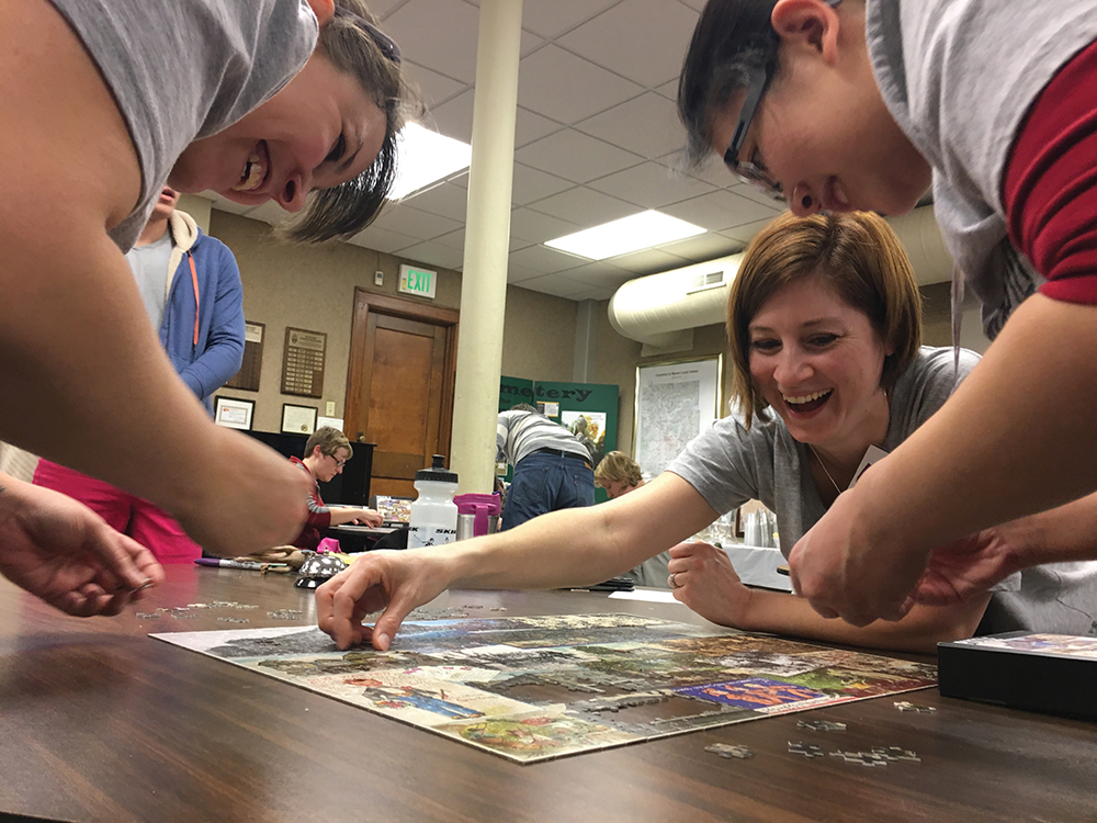 A team works on a jigsaw puzzle at the 2018 Puzzle Fest. Courtesy photo