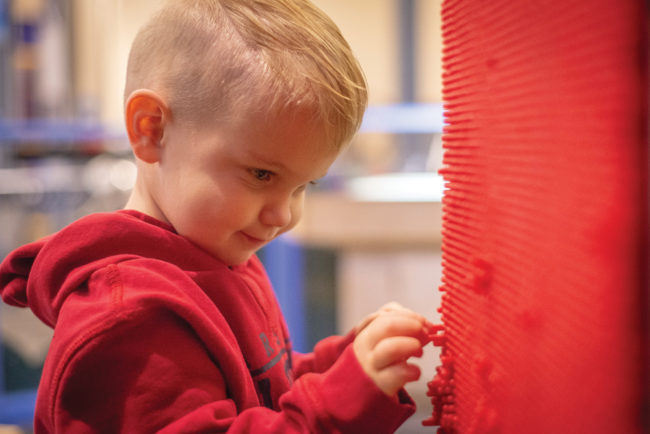 Chandler Pursell, 2, Bloomington, playing at a variety of interactive exhibits at WonderLab.