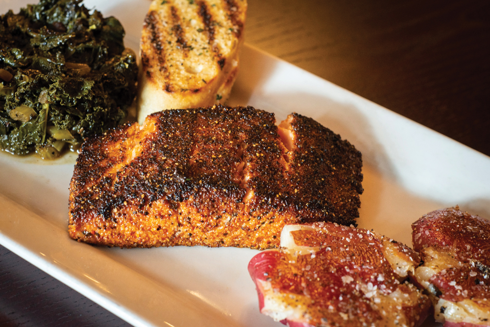 Blackened salmon with Smashed potatoes and sautéed greens.